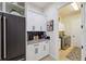 Butler's pantry with built-in cabinets, granite countertops, and stainless steel appliances at 9426 Burnam Dr, Weeki Wachee, FL 34613