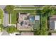 Aerial view of home with solar panels, backyard pool, patio, and putting green at 9774 Bohart Ct, Orlando, FL 32836