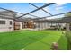 Wide view of backyard with putting green, pool, and patio at 9774 Bohart Ct, Orlando, FL 32836
