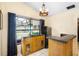 Bright breakfast bar area with built-in cabinets, granite counters, and views of the lanai and pool at 9774 Bohart Ct, Orlando, FL 32836