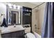 Cozy bathroom with shower, dark cabinets, and full size mirror at 9774 Bohart Ct, Orlando, FL 32836