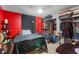Unique bedroom featuring a red accent wall and organized storage at 9774 Bohart Ct, Orlando, FL 32836