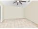 Spacious bedroom featuring tile flooring and a modern ceiling fan at 9774 Bohart Ct, Orlando, FL 32836