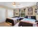 Tan bedroom featuring two beds, storage and natural lighting at 9774 Bohart Ct, Orlando, FL 32836
