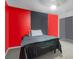 Bedroom with red walls and a black accent wall at 9774 Bohart Ct, Orlando, FL 32836