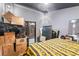 Cluttered bedroom featuring a black ceiling, adjacent doors, and packed moving boxes at 9774 Bohart Ct, Orlando, FL 32836