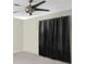 Bedroom featuring a ceiling fan, neutral color, and black curtains at 9774 Bohart Ct, Orlando, FL 32836