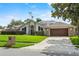 Charming single-story home with a well-manicured lawn, solar panels, and an attached two-car garage at 9774 Bohart Ct, Orlando, FL 32836