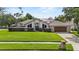 Inviting single-story home boasts a lush green lawn and mature trees, offering a picturesque setting at 9774 Bohart Ct, Orlando, FL 32836
