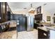 Well-equipped kitchen featuring stainless steel appliances, granite countertops, and dark cabinetry at 9774 Bohart Ct, Orlando, FL 32836