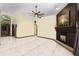 Open living room featuring tile floors, high ceilings, and a fireplace with a brick accent wall at 9774 Bohart Ct, Orlando, FL 32836