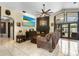 Inviting living room with cozy seating, fireplace, TV, and access to the outdoor pool area at 9774 Bohart Ct, Orlando, FL 32836