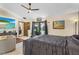 Large main bedroom with a flat screen tv, ceiling fan, tiled floor, and doorway to the en suite bath at 9774 Bohart Ct, Orlando, FL 32836