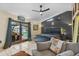 Well-lit main bedroom with modern decor, tiled floors, ceiling fan, and access to the pool and patio at 9774 Bohart Ct, Orlando, FL 32836