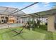 Patio with an outdoor dining set, lounge chair, and hammock overlooking the pool area at 9774 Bohart Ct, Orlando, FL 32836
