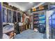 Walk-in closet with custom shelving, clothing racks, and display cases for accessories and shoes at 9774 Bohart Ct, Orlando, FL 32836