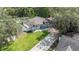 An aerial view showcases the home's layout, landscaping, and proximity to surrounding greenery at 1008 Jackson Creek Ct, Oviedo, FL 32765