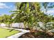 Lush backyard adorned with beautiful banana trees along a white fence, offering a tropical paradise at 1008 Jackson Creek Ct, Oviedo, FL 32765