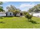 Spacious backyard with well-maintained lawn, tropical trees, and a private setting, great for outdoor activities at 1008 Jackson Creek Ct, Oviedo, FL 32765