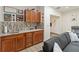 Stylish bar area features wood cabinets, granite counters, mosaic tile backsplash, and unique decor, perfect for entertaining at 1008 Jackson Creek Ct, Oviedo, FL 32765