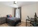 Bedroom with wood floors, a bed, a desk, and a gray dresser and window at 1008 Jackson Creek Ct, Oviedo, FL 32765