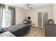 Cozy bedroom with a ceiling fan, natural light, gray accent furniture, and wood flooring at 1008 Jackson Creek Ct, Oviedo, FL 32765