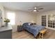 Cozy bedroom with neutral walls, ceiling fan, window with sheer curtain, and access to the outdoors at 1008 Jackson Creek Ct, Oviedo, FL 32765