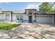 Inviting front exterior with blue door, manicured lawn, and charming details that create excellent curb appeal at 1008 Jackson Creek Ct, Oviedo, FL 32765