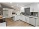 Modern kitchen featuring white cabinetry, stainless steel appliances, and stylish backsplash at 1008 Jackson Creek Ct, Oviedo, FL 32765