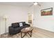 Comfortable living room with a gray sofa, ceiling fan, wood floors, and natural light at 1008 Jackson Creek Ct, Oviedo, FL 32765