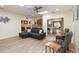 Bright living room with skylight, ceiling fan, and open floor plan connects to the kitchen and dining area at 1008 Jackson Creek Ct, Oviedo, FL 32765