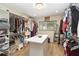 Walk-in closet features many clothes racks, an island with counter top, and a window for natural light at 1008 Jackson Creek Ct, Oviedo, FL 32765