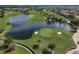 Aerial view of a lush golf course featuring multiple ponds, sand traps, and manicured green spaces at 10836 Tilston Pt, Orlando, FL 32832