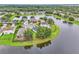 Aerial view of lakefront homes surrounded by mature trees and landscaping at 10836 Tilston Pt, Orlando, FL 32832