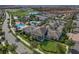 An aerial view of a community featuring tennis courts, swimming pools, and a clubhouse at 10836 Tilston Pt, Orlando, FL 32832
