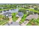 Aerial view of a lakeside property with mature trees, lush landscaping, and a paved driveway at 10836 Tilston Pt, Orlando, FL 32832