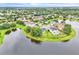 Aerial view of waterfront homes surrounded by mature trees, lush landscaping and lake views at 10836 Tilston Pt, Orlando, FL 32832