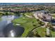 An aerial view showcasing a golf course next to a pond and a neighboring shopping center at 10836 Tilston Pt, Orlando, FL 32832
