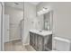Neutral toned bathroom featuring a vanity with drawers, and a glass door shower at 10836 Tilston Pt, Orlando, FL 32832