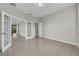 Empty room with tile flooring, neutral walls and French doors leading to another room at 10836 Tilston Pt, Orlando, FL 32832