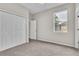 Bedroom featuring neutral walls, plush carpeting, a closet with bi-fold doors and a window at 10836 Tilston Pt, Orlando, FL 32832