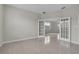 Empty room with tile flooring and French doors leading to another room at 10836 Tilston Pt, Orlando, FL 32832