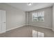 Empty bedroom with tile floors and a single window providing natural light at 10836 Tilston Pt, Orlando, FL 32832