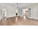 Large bedroom showcasing hardwood floors, neutral walls, and a doorway to the kitchen at 10836 Tilston Pt, Orlando, FL 32832