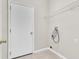 Practical laundry room with tile flooring, utility connections, and overhead shelving at 10836 Tilston Pt, Orlando, FL 32832