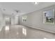 Light-filled living space with tile floors, crown molding, and a welcoming atmosphere at 10836 Tilston Pt, Orlando, FL 32832