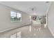 Bright living area with tile floors, large windows, and smooth flow to adjacent kitchen at 10836 Tilston Pt, Orlando, FL 32832
