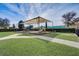 A covered playground featuring slides and climbing structures, set in a well-maintained community park at 10836 Tilston Pt, Orlando, FL 32832