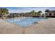 A large swimming pool with a clear blue water, tiled deck and lounge chairs, perfect for community recreation at 10836 Tilston Pt, Orlando, FL 32832