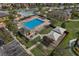 Aerial view of a community pool with splash zone, lounge chairs, cabana, and a covered playground area at 10836 Tilston Pt, Orlando, FL 32832
